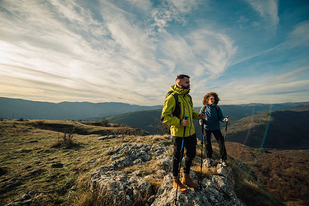 istock Hikers standing on mountain top enjoying scenic view 2235448709