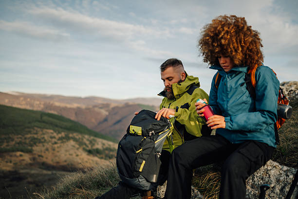 istock Hikers resting on mountain top and taking break during hike 2235448710