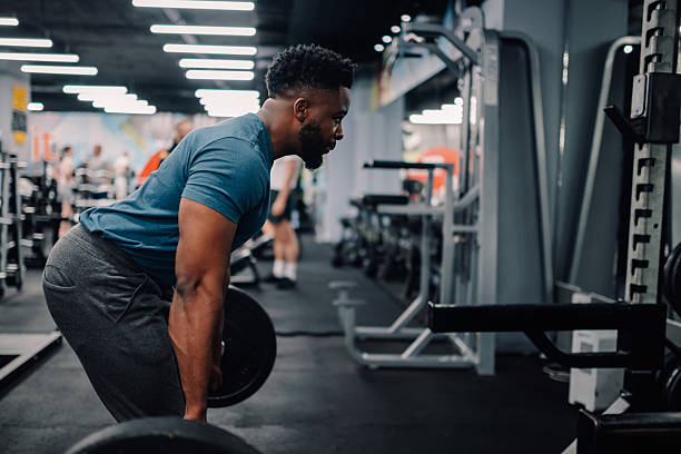 istock Determined bodybuilder lifting weights in gym for muscle growth 2235448781