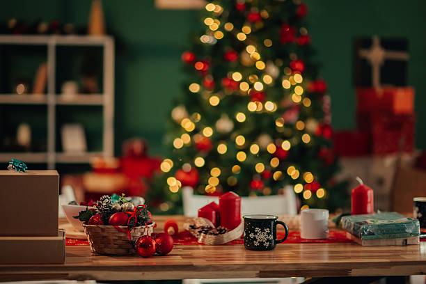 Christmas table decorations with blurred christmas tree in the background