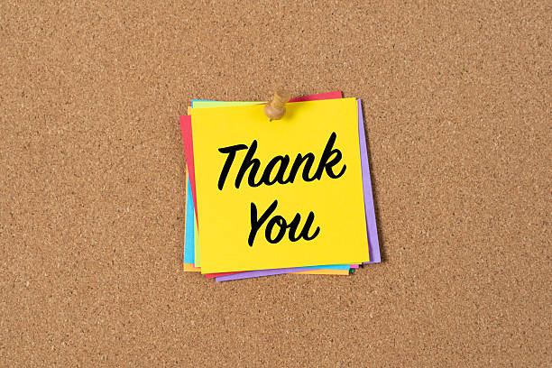 istock Bright Yellow Sticky Note with Thank You Message on Corkboard 2235452143