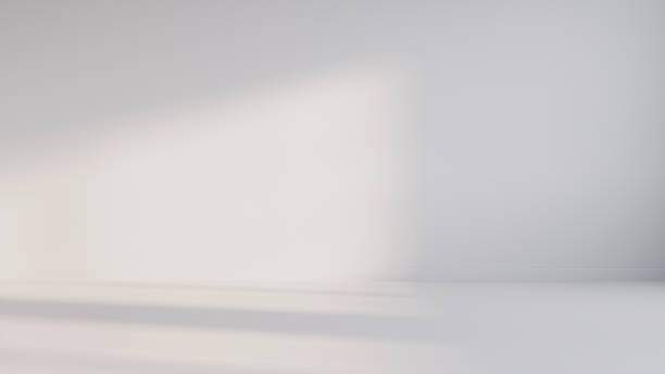 istock Minimalist abstract empty white room for product presentation, with a beam of light falling into the room through the window. 2235453279