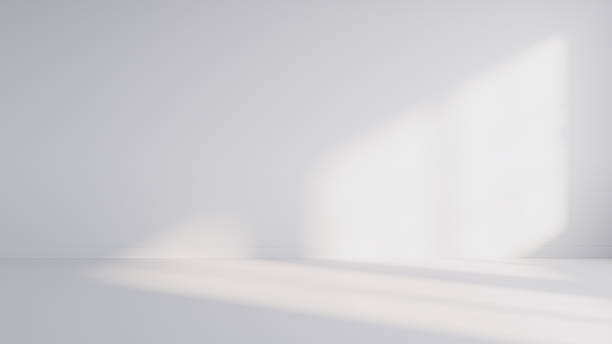 istock Minimalist abstract empty white room for product presentation, with a beam of light falling into the room through the window. 2235453308