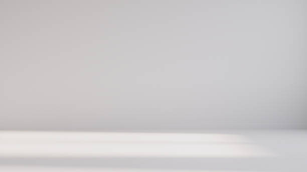 istock Minimalist abstract empty white room for product presentation, with a beam of light falling into the room through the window. 2235453322