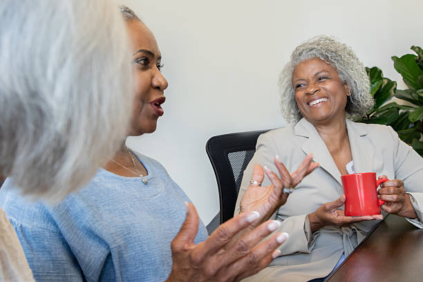 istock Seniors Enjoy Coffee Together in Community Lounge 2235454332