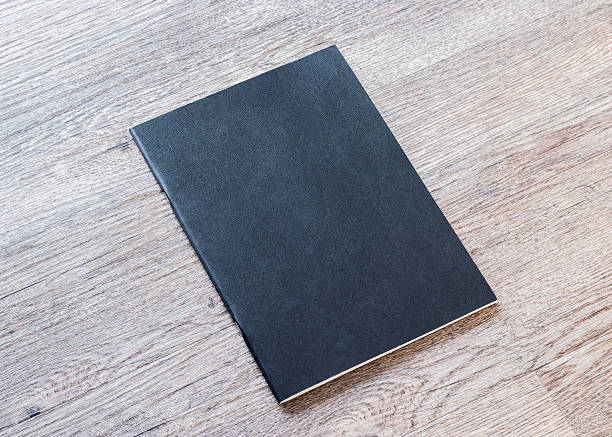 istock Book mockup blank black A4 leather cover for magazine, booklet, brochure, menu, diary mock-up design template on wooden table background 2235456025