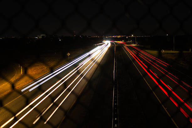 istock Nighttime Traffic Showcasing Dynamic Light Trails on a Busy Highway Under a Starry Sky 2235464535