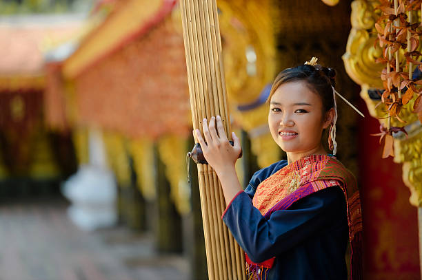 girl in folk costume with folk music called Kaen or can In Wat Wang Kham, Kalasin Province, Thailand