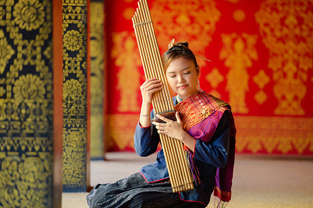 girl in folk costume with folk music called Kaen or can In Wat Wang Kham, Kalasin Province, Thailand