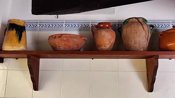 istock Stunning Collection of Beautifully Crafted Earthenware Pots Displayed Elegantly on a Shelf 2235470260