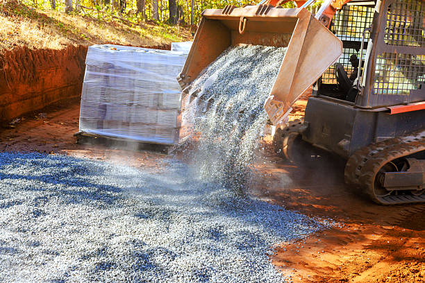 istock Heavy machinery spreads gravel at construction site during daylight hours 2235471597