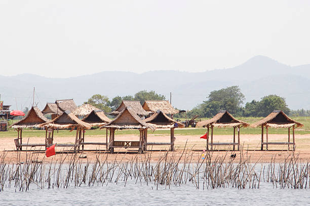 The resting shed is made of bamboo by the lake.