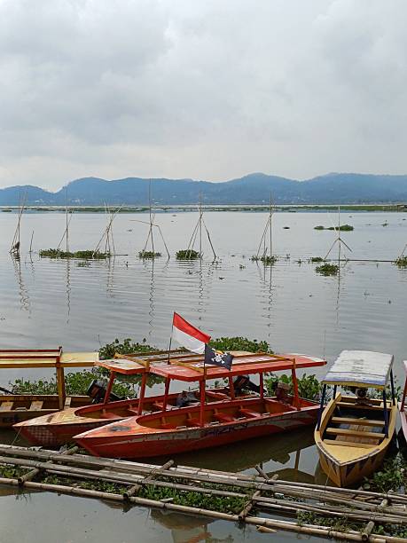 istock Peaceful Lake with Mountains and Boats View 2235473629