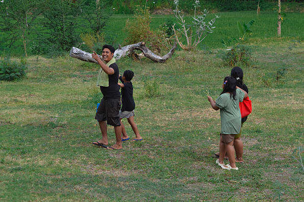 Boy in the courtyard of his house playing the flute