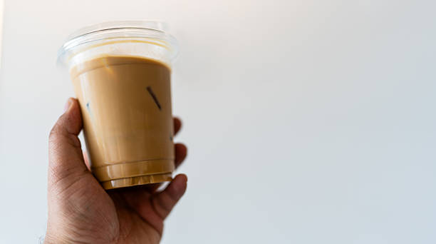 istock Iced coffee latte in hand 2235474358