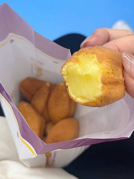 istock Delimanjoo pastry with golden brown shell shaped like a fish, soft fluffy texture filled with sweet custard inside, highlighting its warm color and inviting detail in close-up view 2235480260