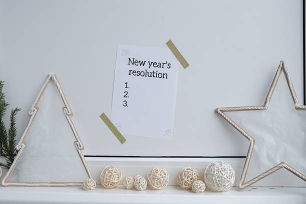 istock Paper note with inspirational to do checklist NEW YEAR'S RESOLUTION with natural zero waste homemade Christmas decor. Happy new year promises resolutions. Self growth and personal development 2235481243