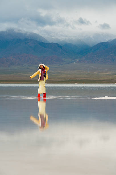 istock Person stands in big landscape, moving forward with hope for future. serene environment reflects beauty of nature and joy of exploration 2235484981