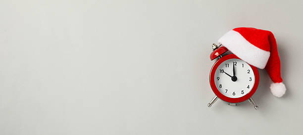 istock A clock with a Santa hat with a New Year's decoration. 2235492092