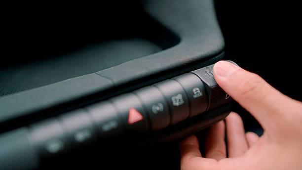A close-up view of a car driver pulling a lever on his control panel before starting to drive to his destination.