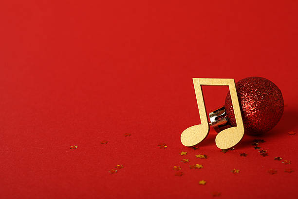 istock Golden musical notes with a ball on a red background 2235492487