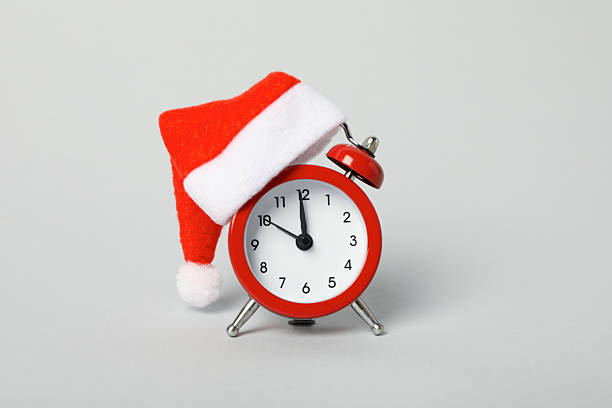 istock A clock with a Santa hat with a New Year's decoration. 2235493100