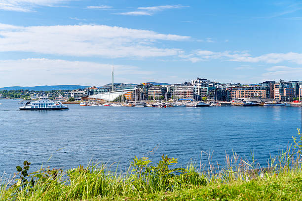 Oslo Harbor with ships and famous Opera House. Coastal capital Norway with fjords and modern architecture.