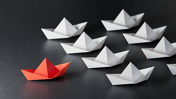istock Different business concept.new ideas. paper art style. creative idea.Leadership concept, black leader boat leading white boats.3D rendering on black background. 2235494783