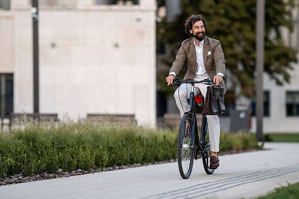 istock Businessman riding bicycle in urban setting, embracing sustainable commute 2235495399