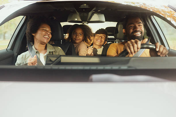 istock Happy black family having fun during road trip by car. 2235498666