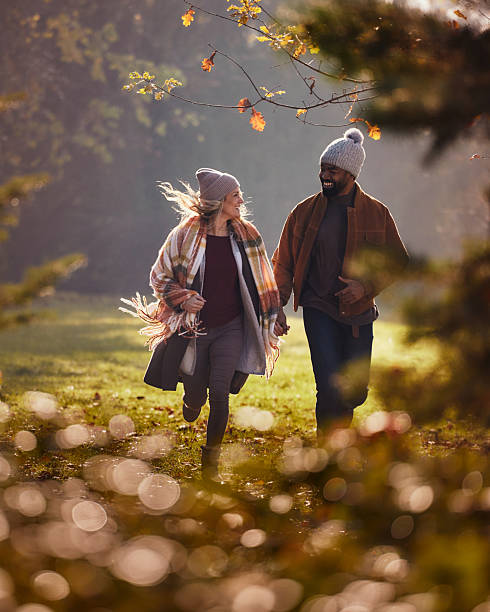 istock Carefree couple having fun while running in autumn day. 2235499093