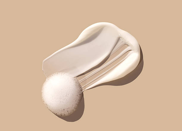 istock sample smear of creamy white texture on light beige background close up 2235499896