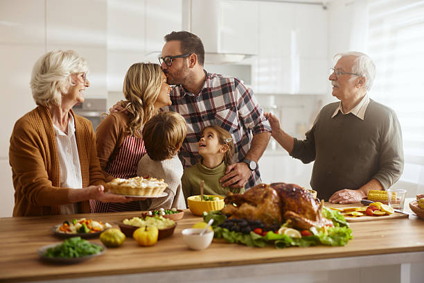 istock Affectionate extended family enjoying on Thanksgiving in the kitchen. 2235500220