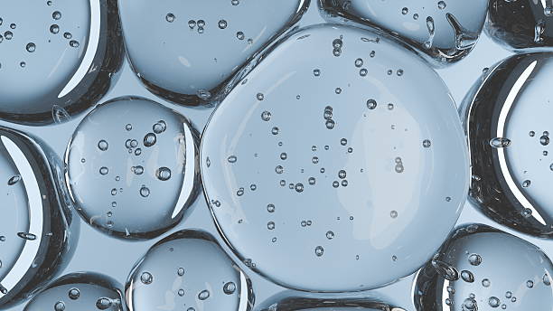 istock Clusters of spherical bubbles and droplets float within a clear liquid, showcasing a mesmerizing arrangement that captures light and reflections, creating depth and interest. 3d render 2235500467