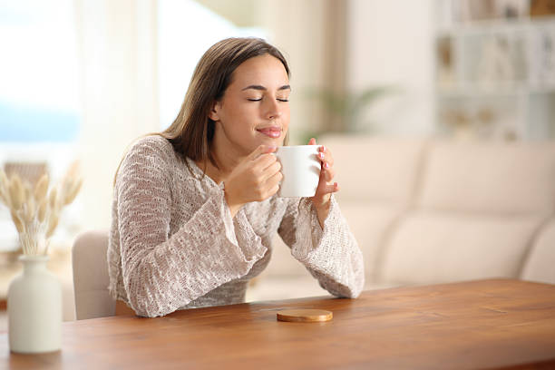 istock Coffee lover smelling aroma from cup at home 2235501223