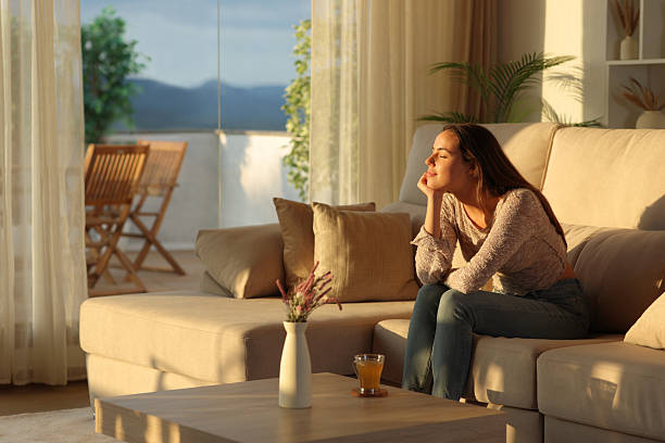 istock Relaxed woman resting with closed eyes sitting at home 2235501358