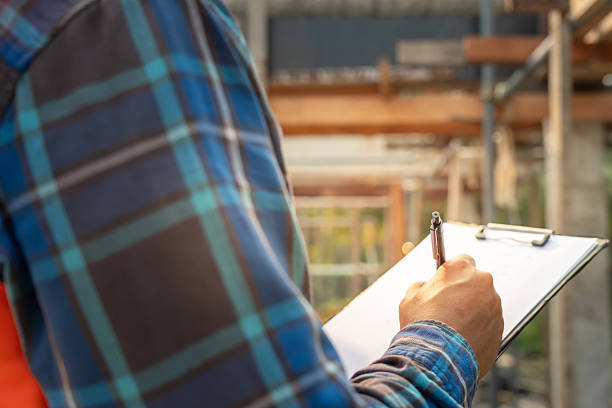 istock inspector or engineer is inspecting construction and quality assurance new house using a checklist. Engineers or architects or contactor work to build the house before handing it over to the homeowner 2235501834