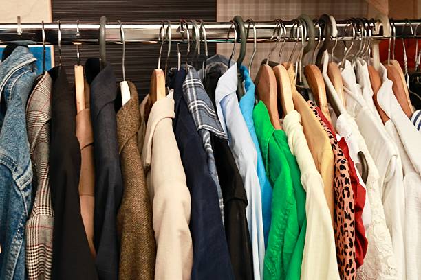istock Clothes on hangers. Clothes on wardrobe. Dressing room. 2235502018