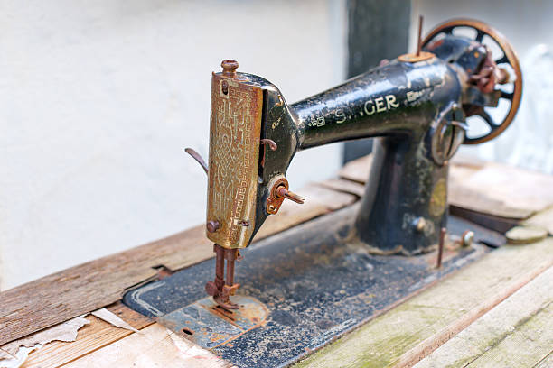 Hattingen, Germany - June 14, 2025: Close-up view of a vintage Singer sewing machine positioned on wooden planks in Hattingen, Germany, highlighting its intricate details and aged patina.