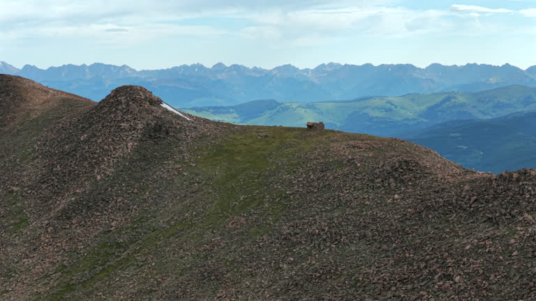 Morning Halo Ridge Notch Mountain Shelter Gore Range Vail Minturn Redcliff aerial drone Colorado sunny blue sky summer Mount Holy Cross 14er peak Wilderness Sawatch Range Rocky Mountains forwards pan