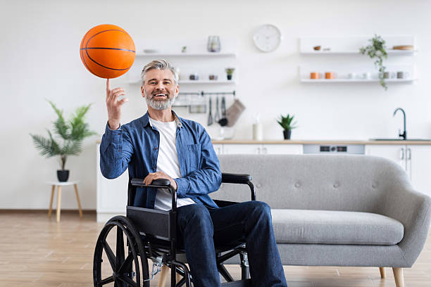 istock Disabled man practicing basketball skills while in wheelchair indoors 2235505218