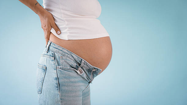 istock Pregnant Woman with Back Pain 2235505527