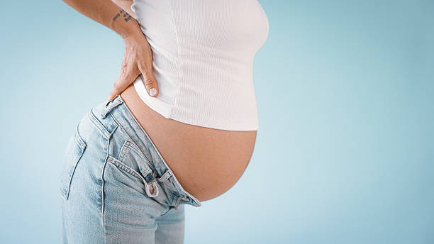 istock Pregnant Woman with Back Pain 2235505543
