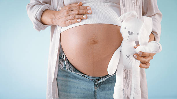 istock Pregnant Woman Holding Teddy Bear 2235505681