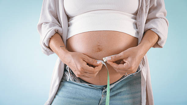 Pregnant Woman Measuring Belly