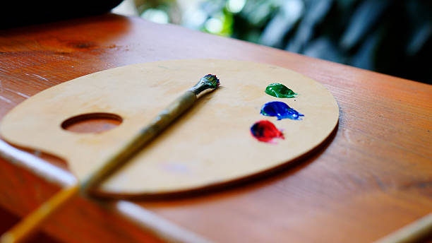 istock A beautiful artists palette featuring vibrant colors along with a paintbrush for use 2235505942