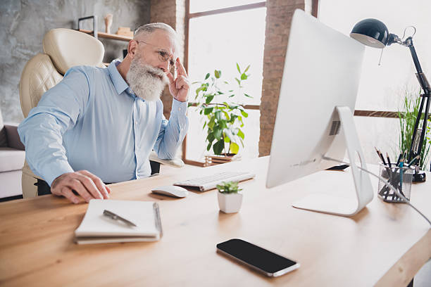 istock Portrait of attractive worried middle-aged skilled man working hard overthinking solution rejoicing at office house indoor 2235507227