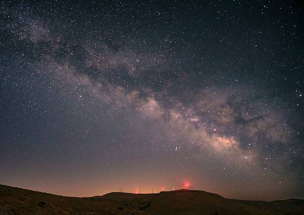 istock Milky Way over hills with red lights at night. 2235508282