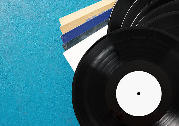 Isolated black vinyl record with red center label on white background concept of retro music
