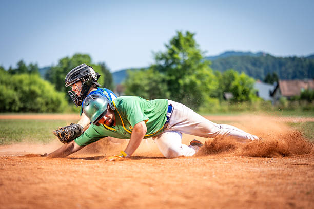 istock Baseball Player Sliding into Base, Kicking up Dirt 2235510115